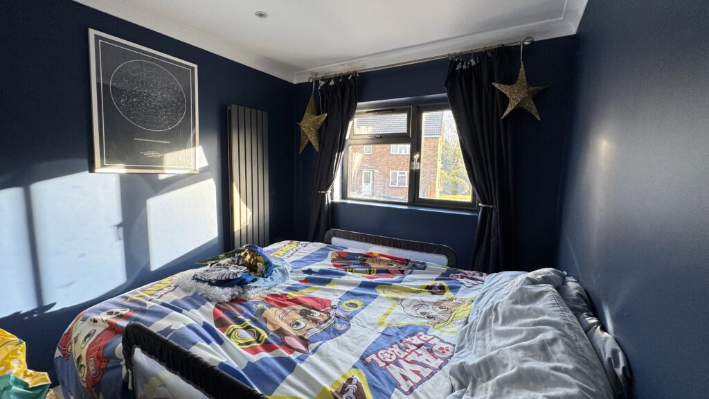 Bright kids bedroom within a rear ground floor extension with whole house refurbishment, featuring playful decor and ample natural light.