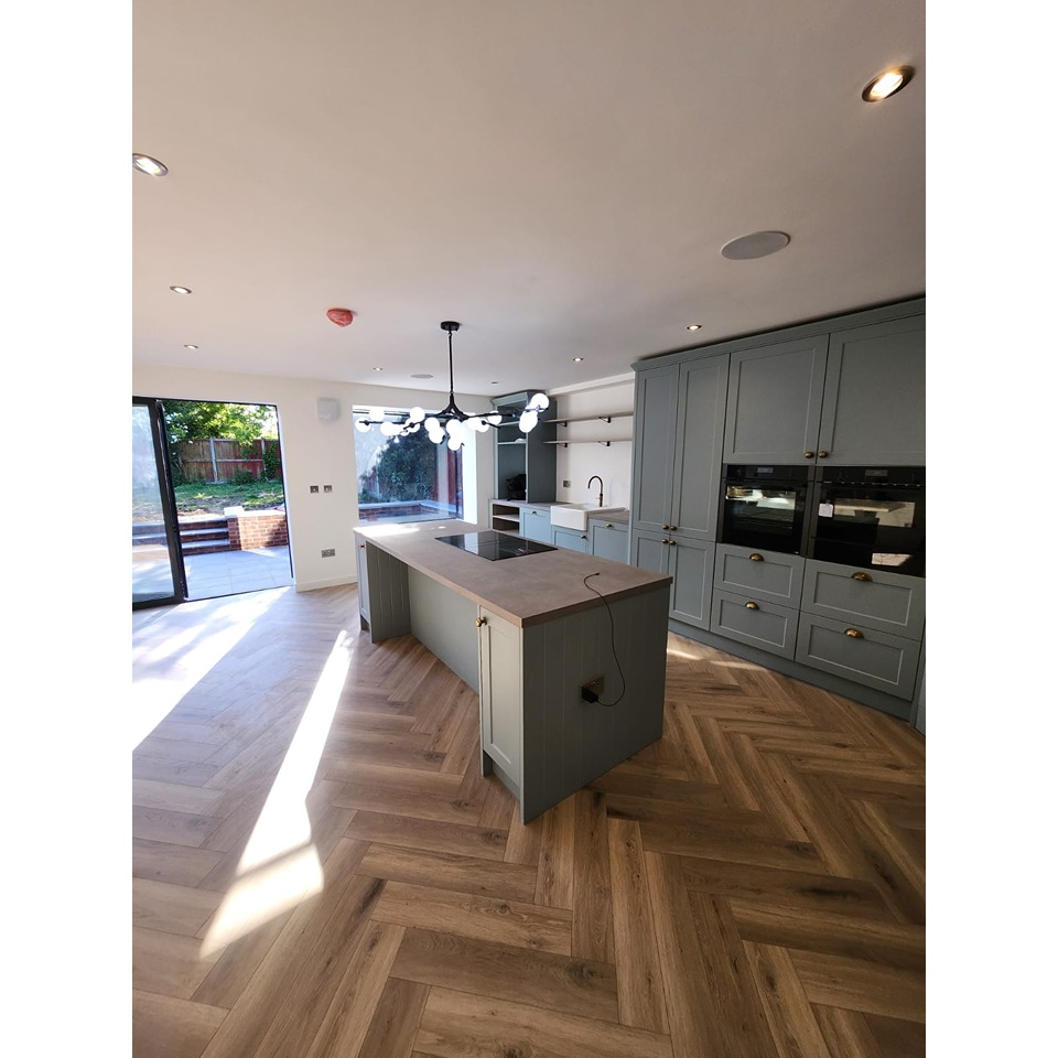 Modern style kitchen with herringbone laminate flooring