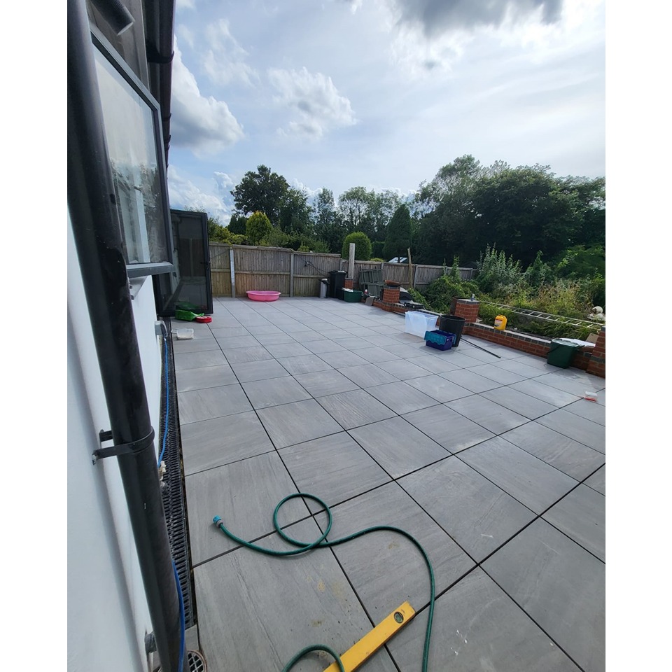 Backside of the house with a Patio and traditional slabs